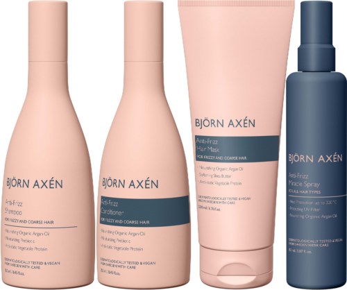 Vijf haarverzorgingsflessen en één sprayfles in roze en donkerblauwe kleuren, gelabeld Björn Axén Anti-Frizz haarproducten.