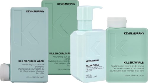A set of Kevin Murphy hair products, including wash, turls, and curls rinse in green bottles.