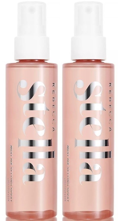 Two pink spray bottles with white caps and large white text. They are aligned vertically, likely hair or cosmetic products.