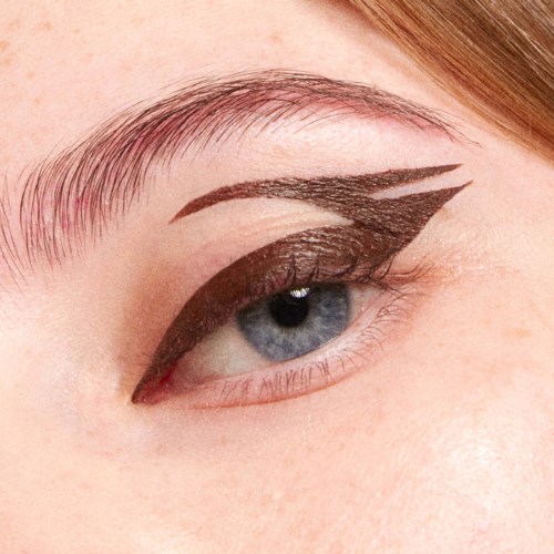 A close-up of an eye with dramatic black eyeliner and artistic winged design on the eyelid.