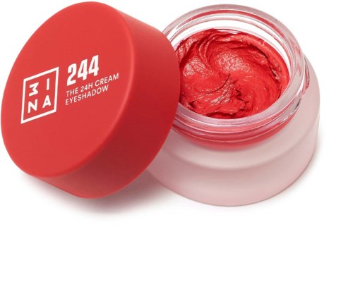 En liten burk med ljusröd kräm och matchande röd lock, märkt 'MUA 244 THE 24H CREAM EYESHADOW.'