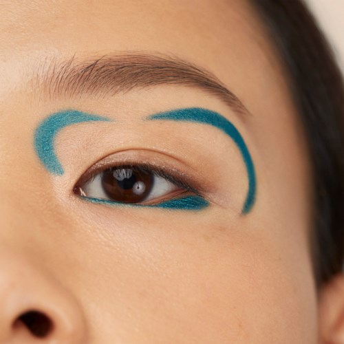 The eye has blue makeup lines above and below, emphasizing the eyelid area.