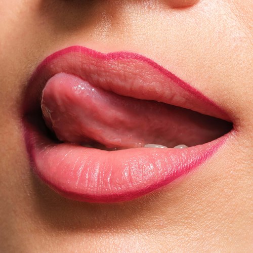 Close-up of lips with lipstick and tongue partially sticking out.
