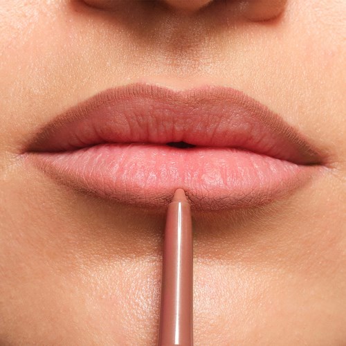 Close-up of lips with a lip pencil, ready to draw or apply lipstick.