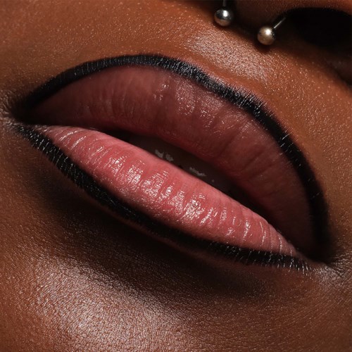 Close-up of lips with bold black lipstick and a lip ring. The skin is smooth and makeup is striking.