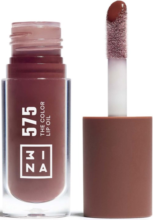Lippenstiftflasche mit Schwammapplikator daneben, beide in sanften rosa-braunen Tönen.