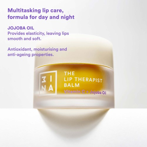 A jar of lip balm with yellow and white packaging, stating it contains Jojoba Oil and Vitamin C, designed for soft, moisturized lips.