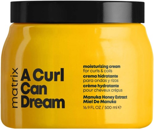 Gelber Behälter mit feuchtigkeitsspendender Creme für Locken, beschriftet 'A Curl Can Dream' mit schwarzem Deckel und Text.