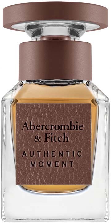 Een parfumfles met een bruine dop, doorzichtige body en een bruin label met 'Abercrombie & Fitch Authentic Moment.'