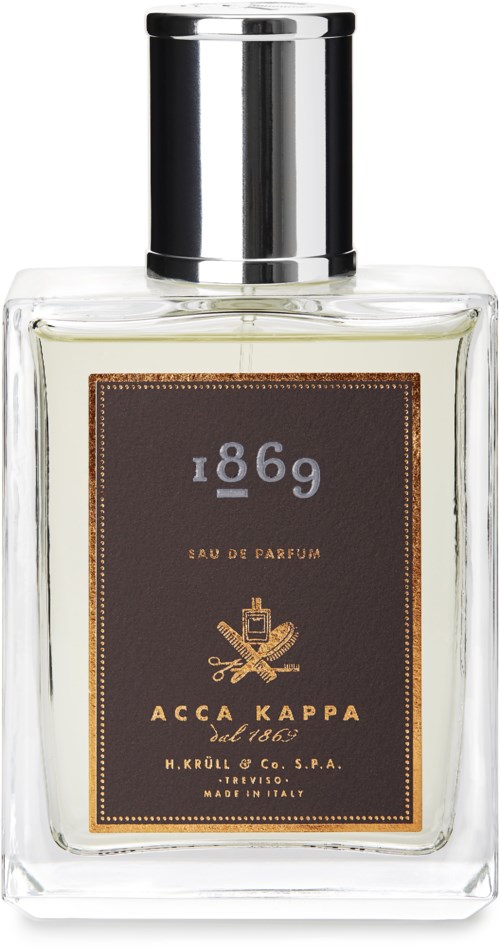 Ein Parfümflasche mit schwarzem Etikett, silberner Kappe und goldener Schrift und Design auf der Vorderseite.