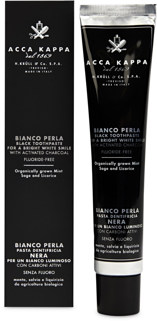 Black toothpaste tube with white text, plant images, and a black and white box. It promotes natural ingredients and bright teeth.