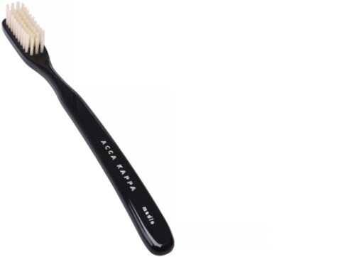 A black toothbrush with white bristles, labeled 'Acca Kappa  x  Carbo,' against a white background.