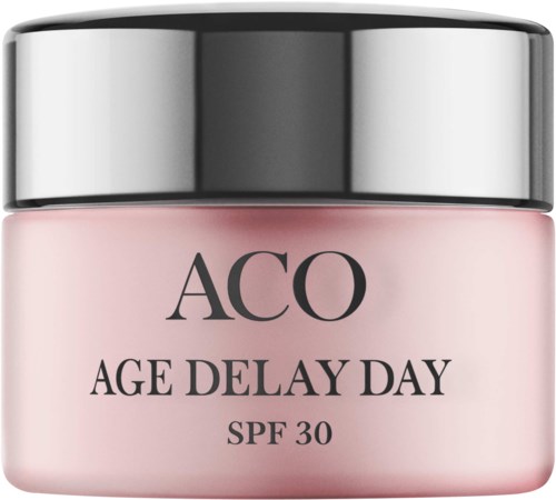 En burk med hudvårdsprodukt märkt 'AGE DELAY DAY' med SPF 30, rosa kropp och silverlock.