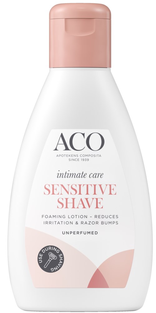 En vit flaska med rosa kork, märkt 'ACO Sensitive Shave' för känslig hud, med en mjuk design och text.