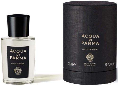 A perfume bottle and its round black box with gold text for Acqua di Parma Luce di Rosa.