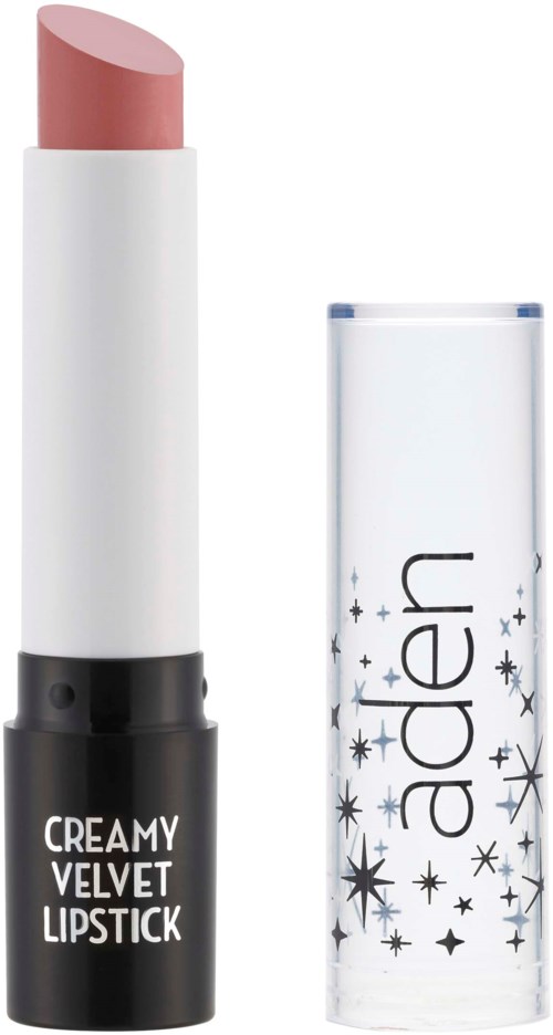Ett läppstift i en vit hylsa med svart bas, märkt 'CREAMY VELVET LIPSTICK.' Capen är genomskinlig med stjärnformer.