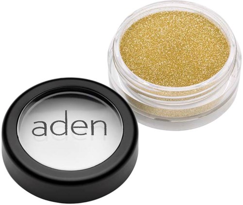 A small round container with gold glitter and a black lid labeled 'aden'.