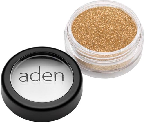 Een kleine container met gouden glitter en een zwart-wit label met de tekst "aden".