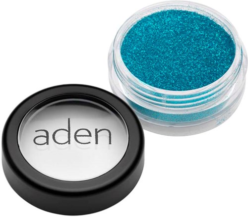 A small open container with blue glitter and a round black lid with the word "aden" on it.