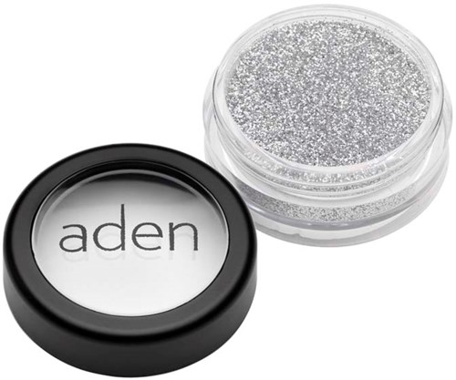 A small jar of silver glitter and a container with the word 'aden' on it.