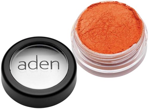 A cosmetic container with orange powder inside, and a lid with the brand name 'aden' on it.