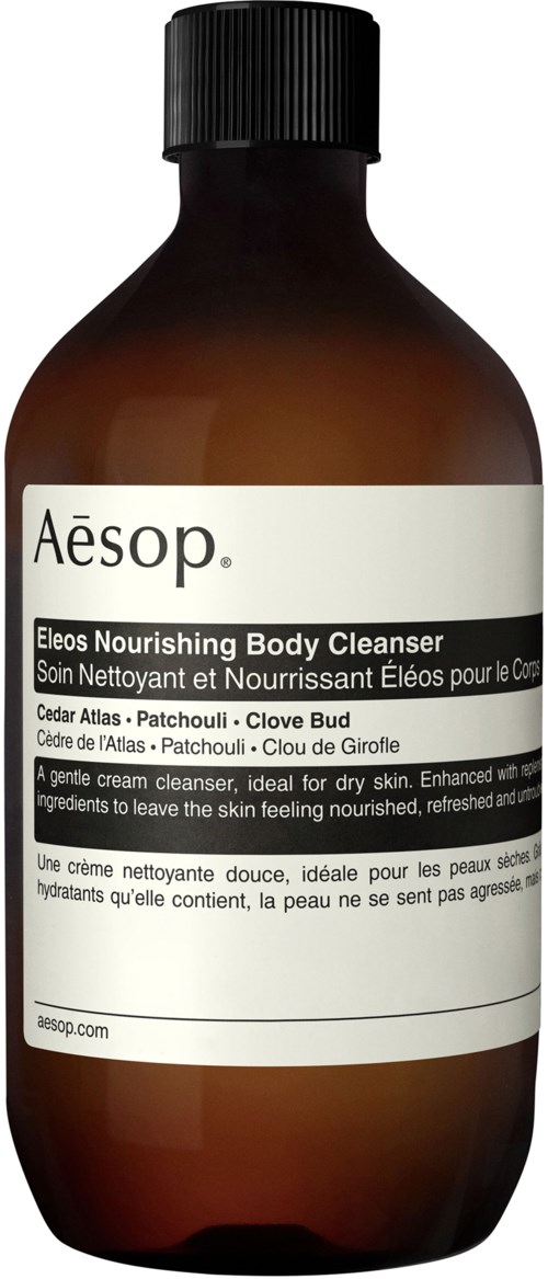 Eine braune Flasche von Aesop Eleos nährender Körperreiniger mit weißem Etikett und schwarzem Deckel.