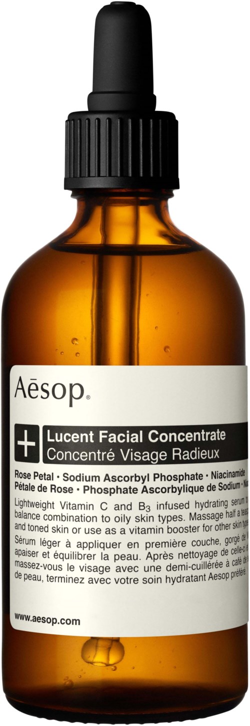 Bernsteinfarbene Glasflasche mit schwarzem Tropfenzähler, beschriftet Aesop Lucent Facial Concentrate, enthält Hautpflegeprodukt.