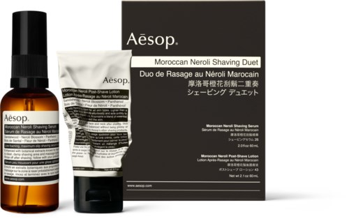 Aloe vera products in bottles and boxes, including shaving serum and lotion, with black, white, and orange packaging.