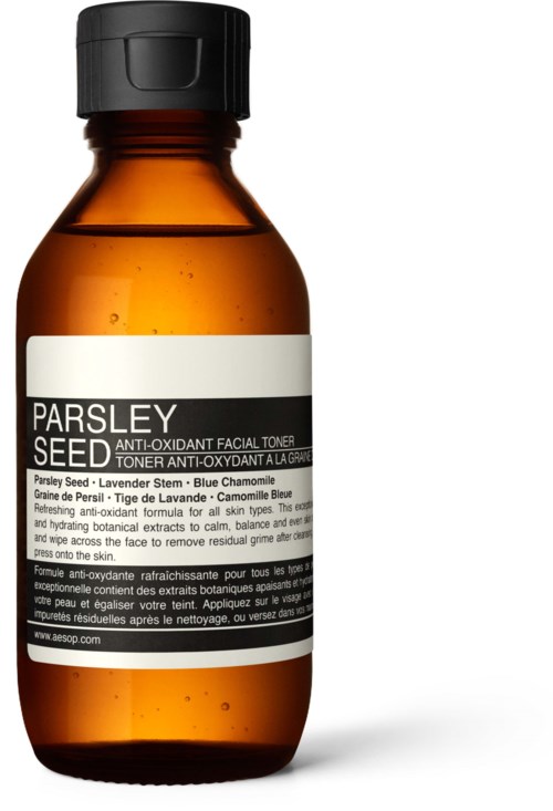 Eine braune Flasche mit schwarzen Deckel und weißem Etikett, das Parsley Seed Anti-Oxidant Facial Toner sagt.