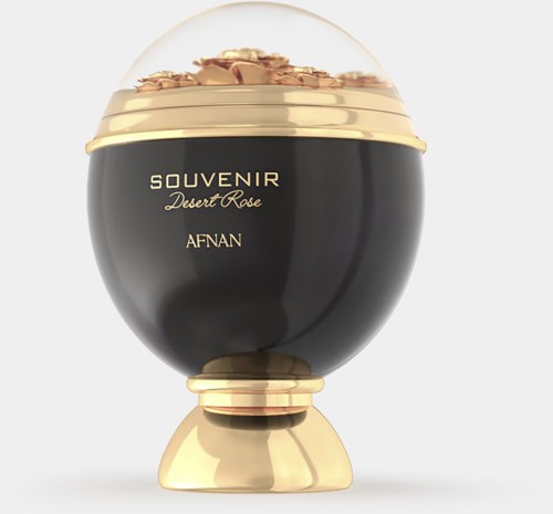 En svart og gull dekorativ beholder med ordene "Souvenir Desert Rose AFNAN" på, fylt med tørkede roseblader.