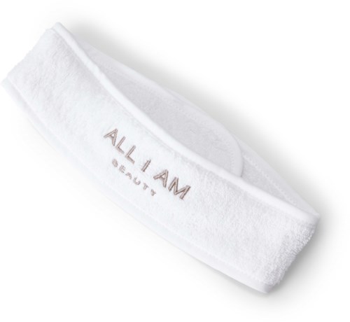 Biała opaska na głowę z tekstem "ALL I AM" i "BEAUTY".