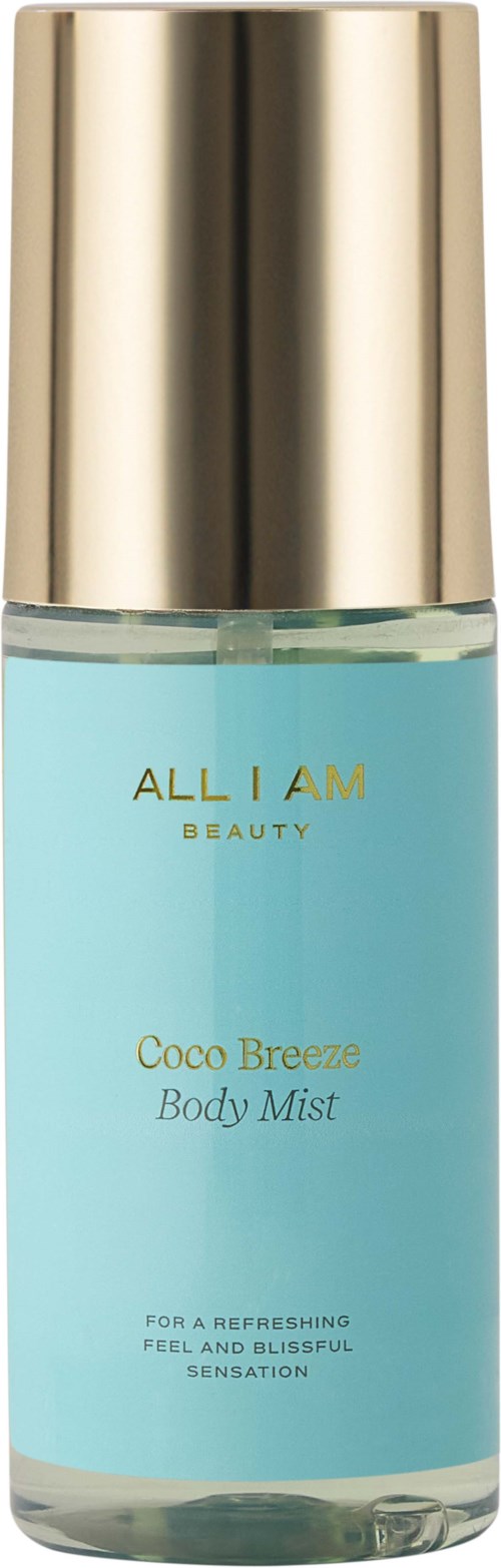Een lichtblauw sprayflesje met een gouden dop, gemarkeerd 'Coco Breeze Body Mist' van All I Am Beauty.
