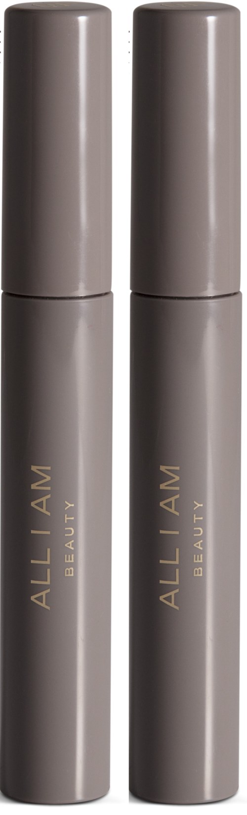 Two gray cylindrical bottles with gold text saying "ALL I AM BEAUTY" stand upright.