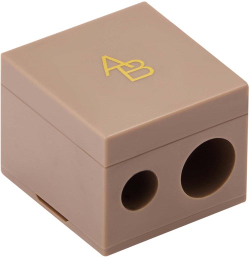 A beige jewelry box with gold initials 'AB' on top and circular holes on the side.