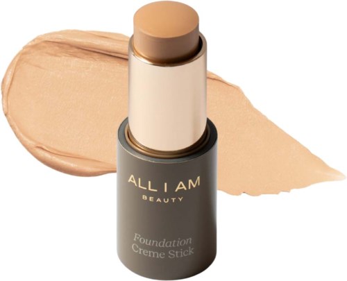Foundation stick in a gray container with a beige swatch and cream-colored background.