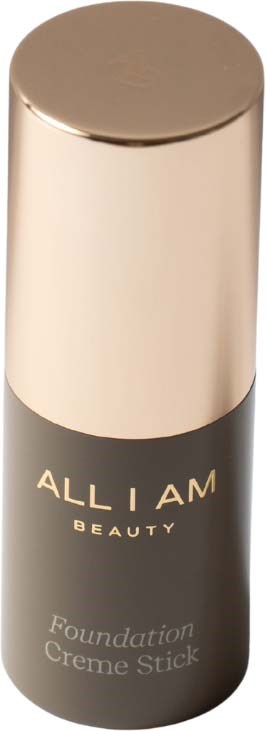 A bottle of Allium Beauty foundation stick, black with a gold cap, standing upright.