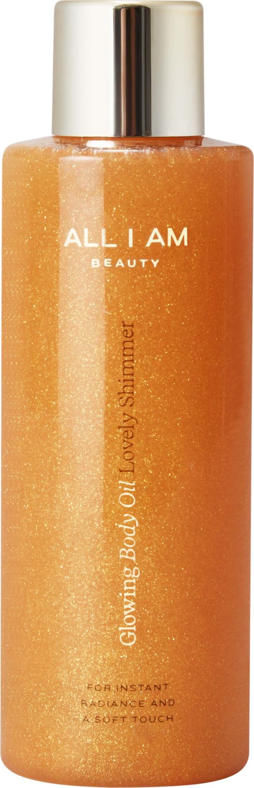 Een lange fles met een glimmende zilveren dop, oranje vloeistof en de woorden "ALL I AM BEAUTY" op de fles.