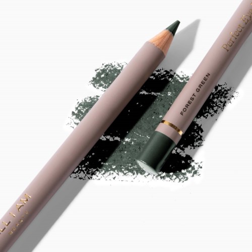 A pen with a green tip and a beige body, lying on a green ink smudge. The pen has gold accents.