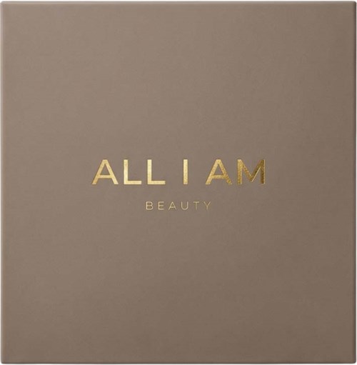 A beige box with gold text: "ALL I AM BEAUTY".