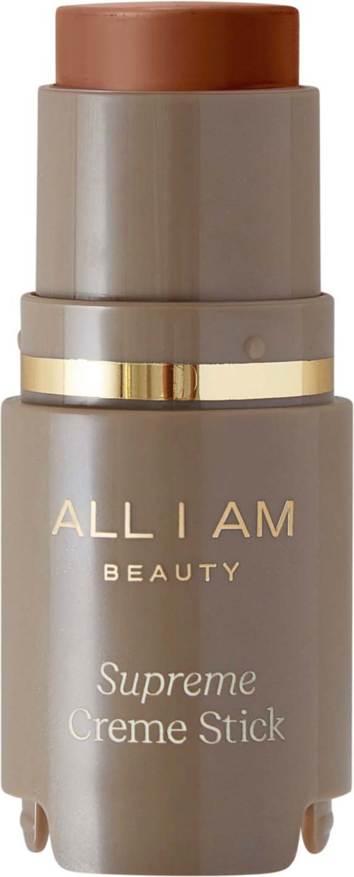 Eine beige Flasche mit goldenen Akzenten, beschriftet mit 'ALL I AM BEAUTY' und 'Supreme Creme Stick'.