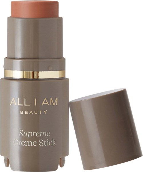 A beige stick with a cap, labeled "ALL I AM BEAUTY Suprema Creme Stick," for face makeup.