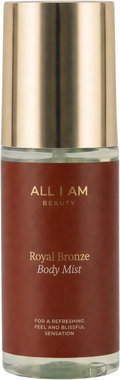 En kroppssprayflaska med guldlock, märkt All I Am Beauty Royal Bronze, för att fräscha upp huden och skapa en glad känsla.
