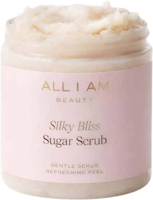 En burk med Silky Bliss Sugar Scrub med ett krämigt, fluffigt täcke och en ljusrosa etikett.