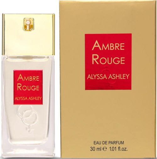 A perfume bottle and box labeled 'Ambre Rouge' by Alyssa Ashley, gold cap, red and yellow label.