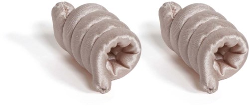 Two soft, beige, striped hair rollers with open ends, lying on a white surface.