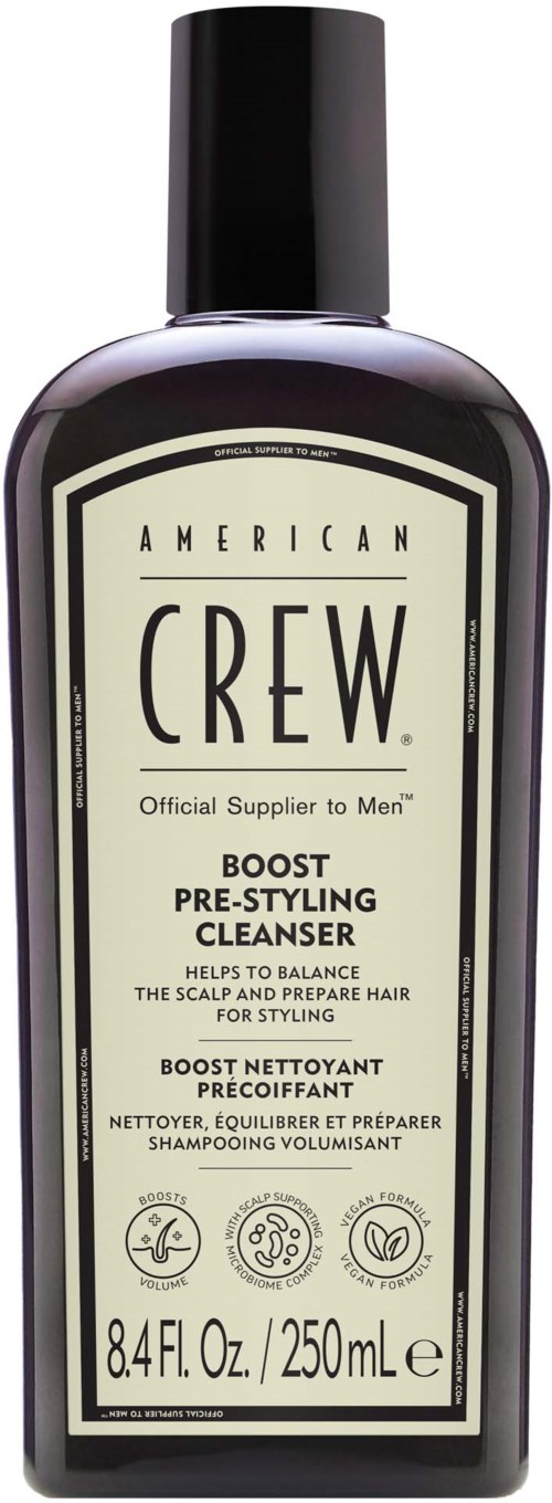 Een zwarte fles met een crèmekleurig etiket met het American Crew-logo en tekst over een pre-styling cleanser.