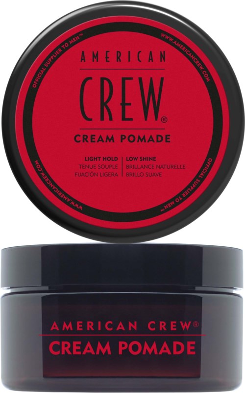 A black and red container of American Crew Cream Pomade for hair styling, featuring product details on the label.