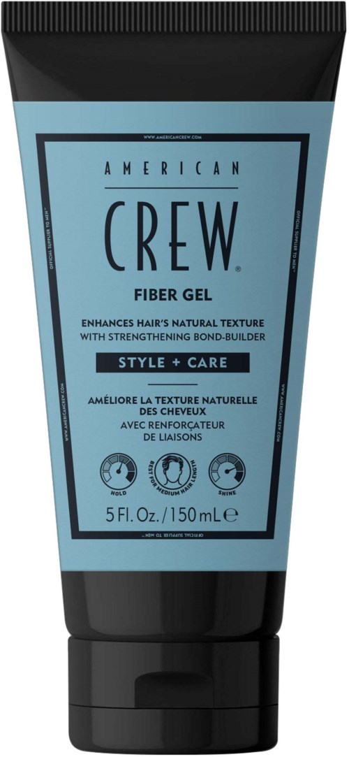 A blue and black tube of American Crew Fiber Gel for hair, with text describing its benefits and size.