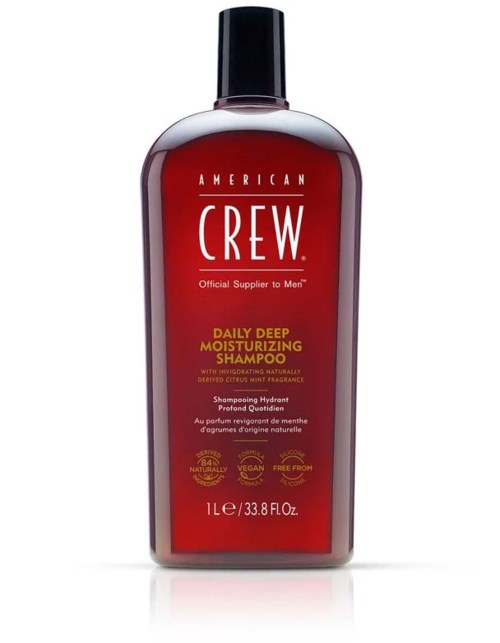 Red bottle of American Crew moisturizing shampoo with black cap and white text.