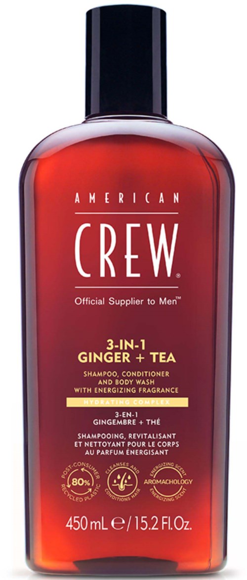 Een rood flesje van American Crew 3-in-1 gember en thee shampoo, conditioner en lichaamswas, met een zwarte dop.